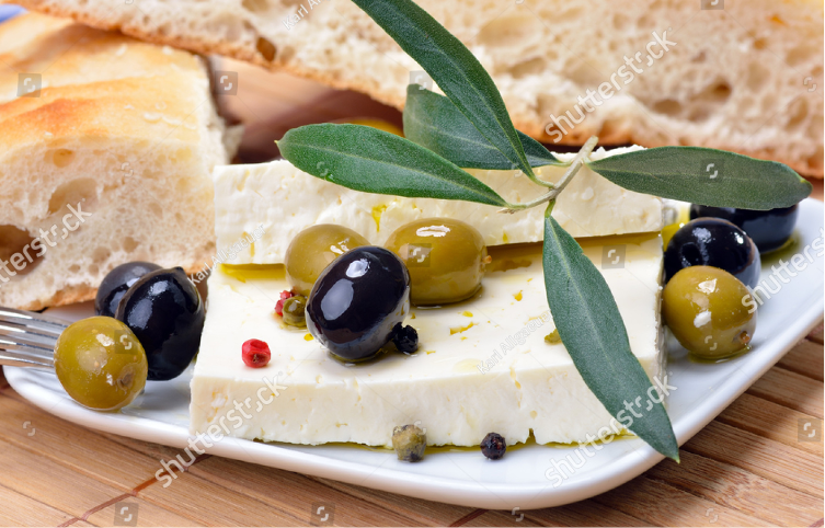 stock-photo-greek-cheese-with-green-and-black-olives-decorated-by-olive-leaves-77734606